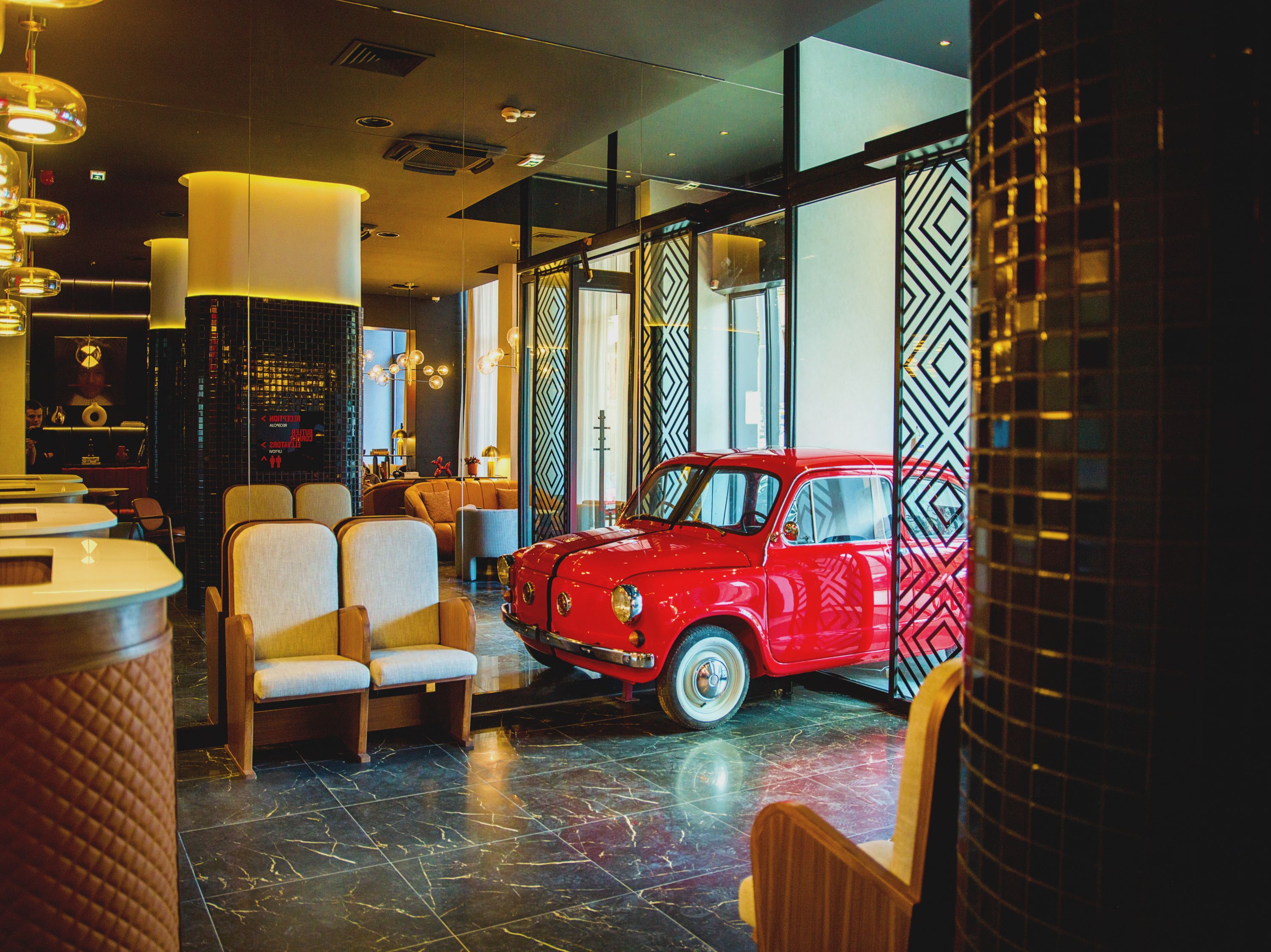 Lobby: A red “Fićo” Zastava 750 car -  a creative symbol of the fusion between past and present